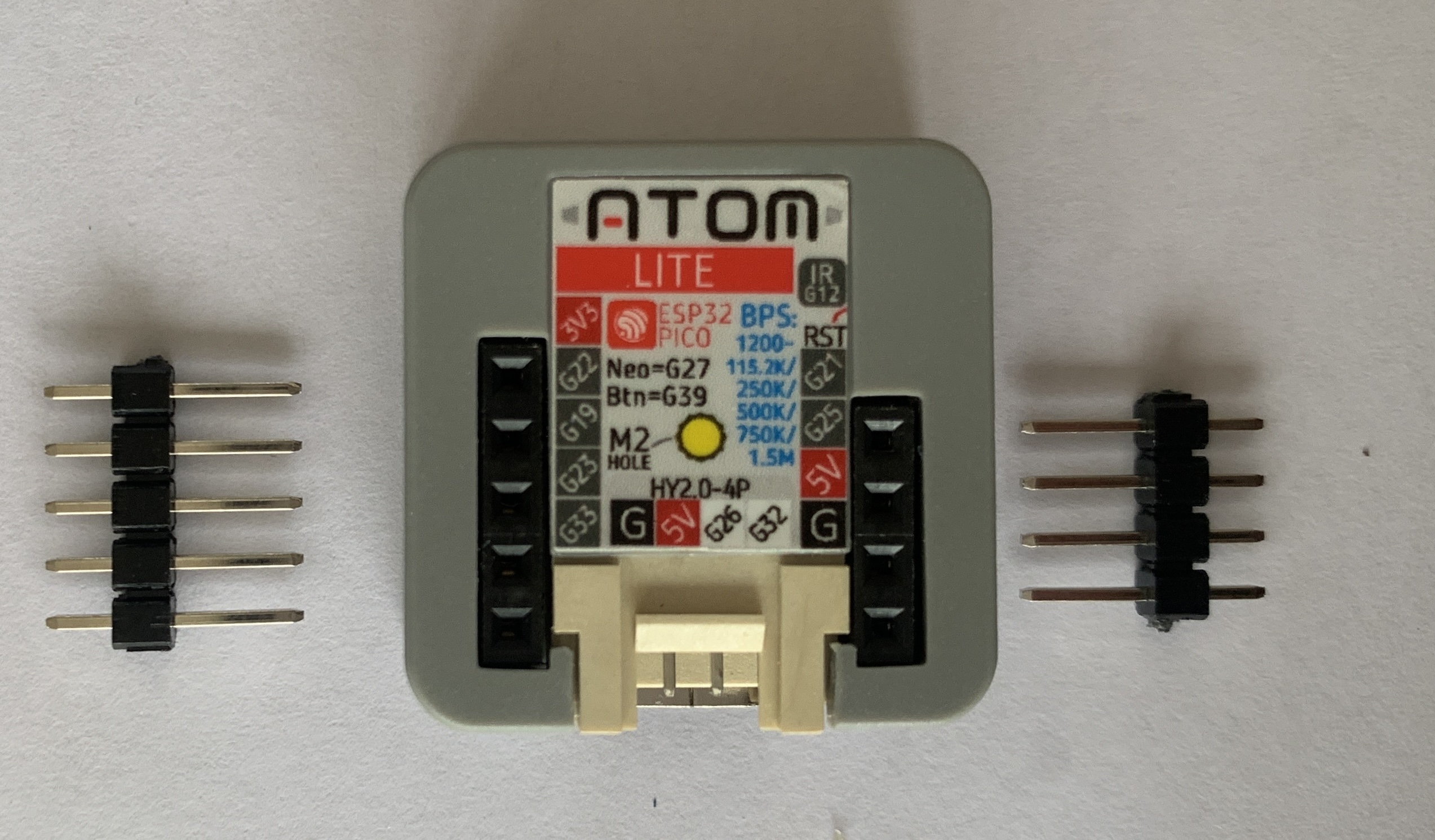 Atom Lite next to its socket headers.